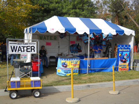 The Harvey Girl Historical Society selling bottled water and balloons at a Thomas the Train event.